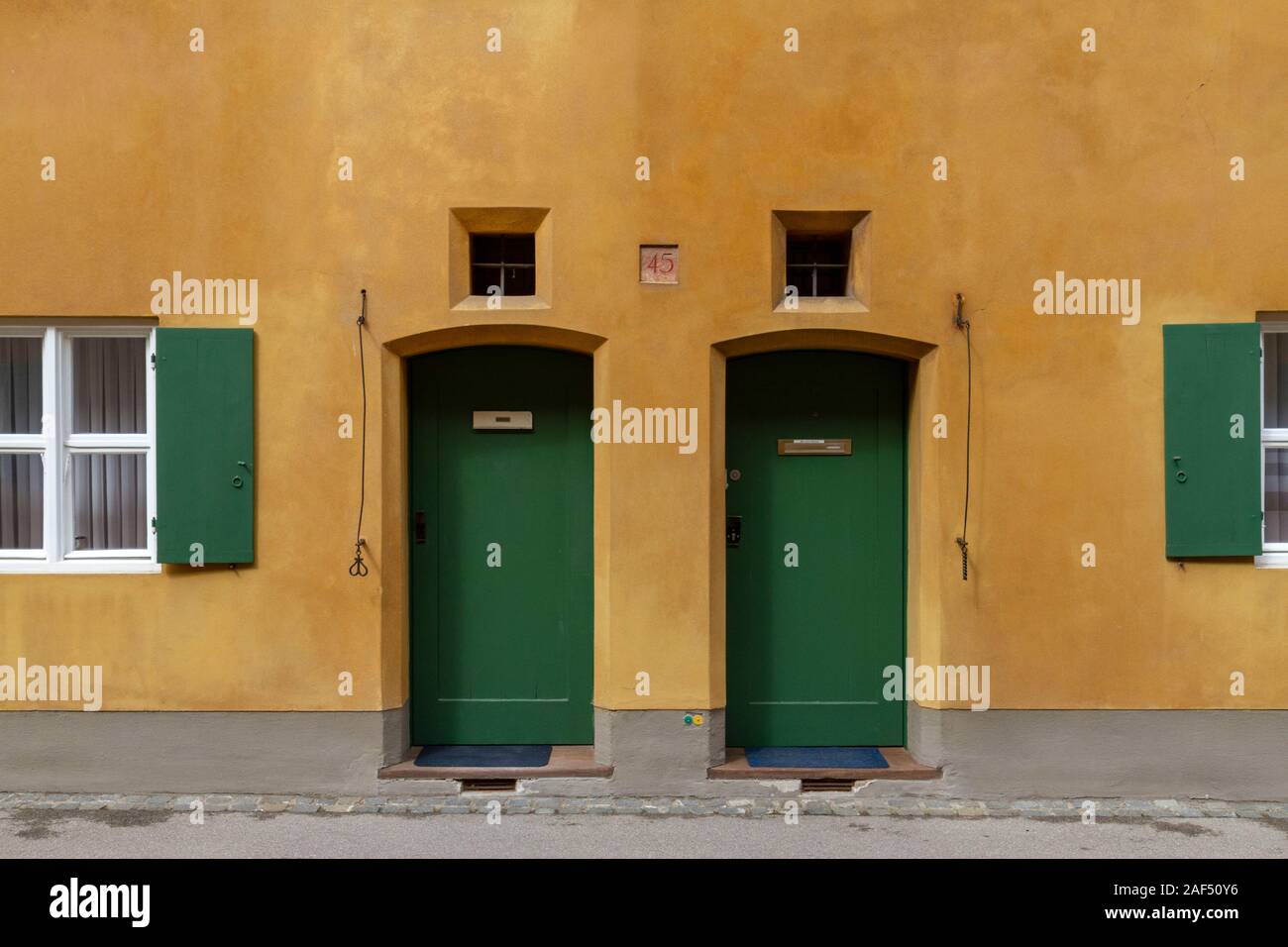 Typical low doors in the Fuggerei, a walled enclave within the city of Augsburg, Bavaria, Germany. Stock Photo
