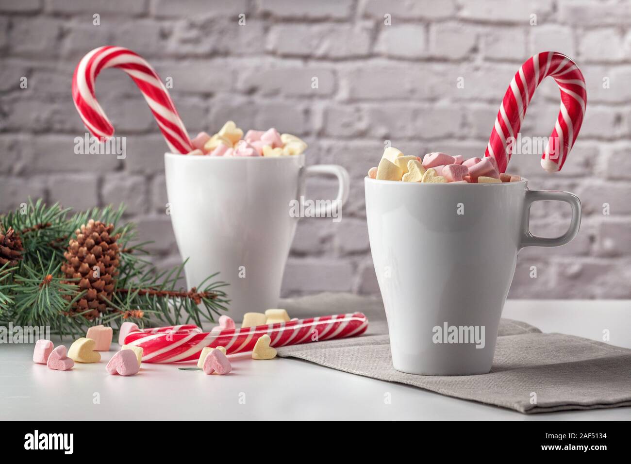 marshmallows and a cup of latte on a white table Stock Photo