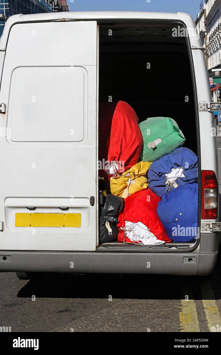 Laundry cleaning service delivery van with bags Stock Photo Alamy