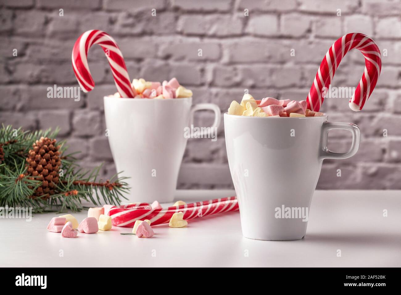 marshmallows and a cup of latte on a white table Stock Photo