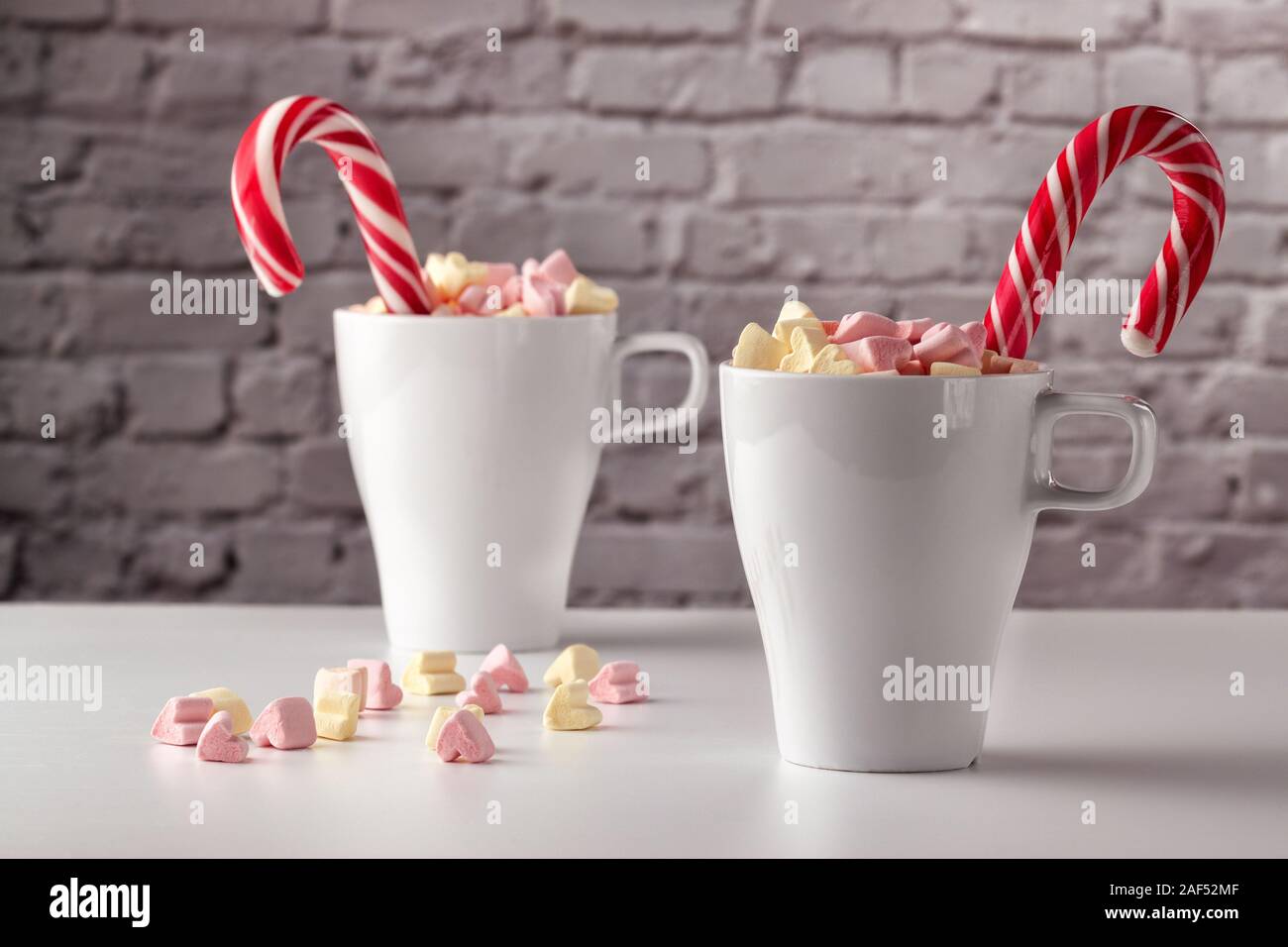 marshmallows and a cup of latte on a white table Stock Photo