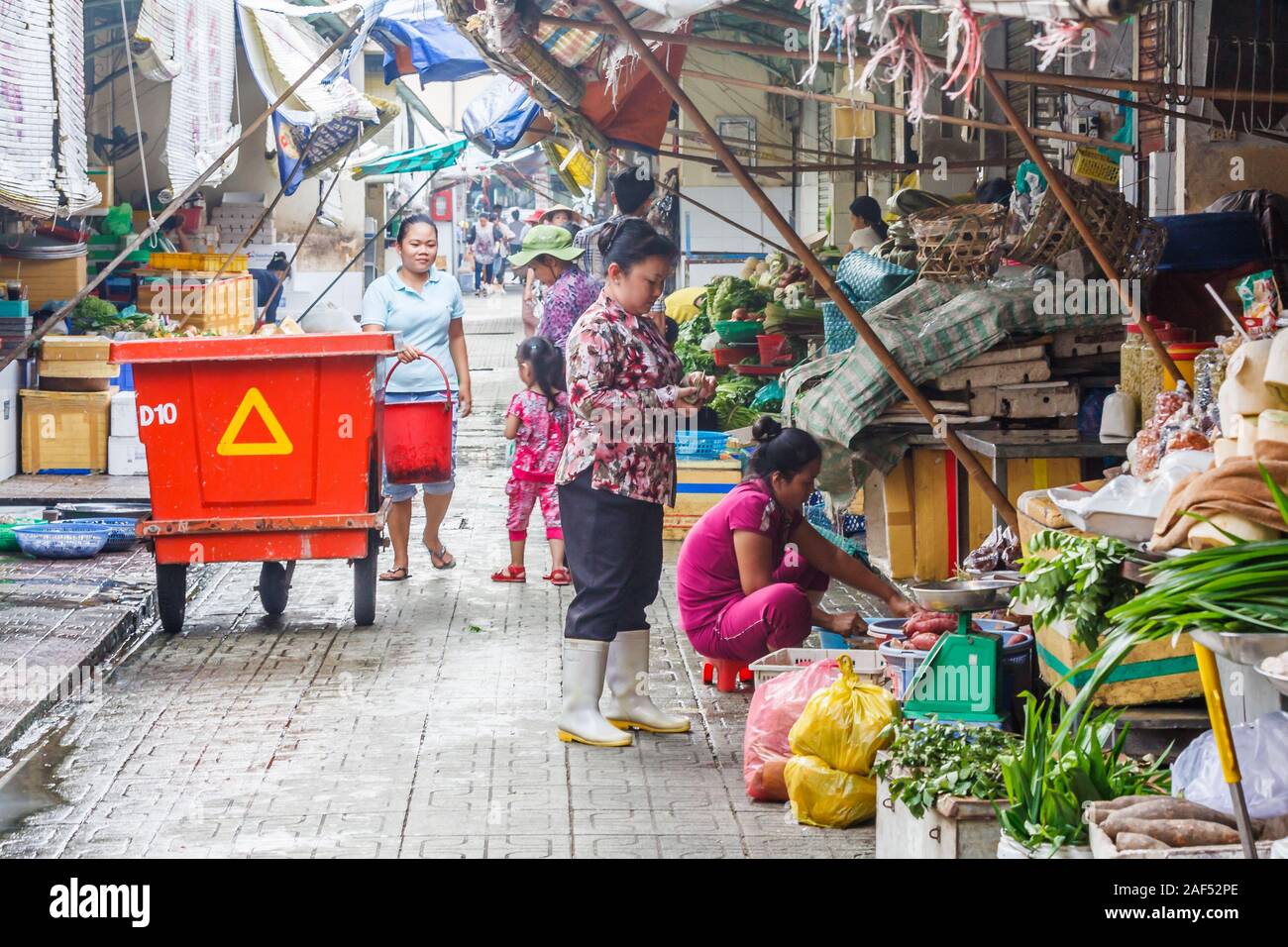 Ho Chi Minh City, Vietnam - October 29th 2013: Typical side street scene. Markets and food shops abound in the city. Stock Photo