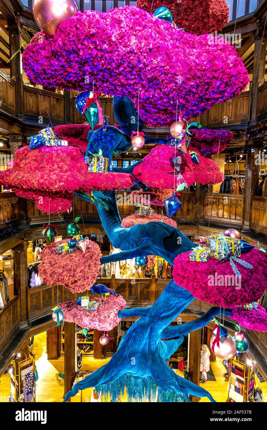 A large Christmas tree in a Japanese bonsai style made of reindeer moss suspended from the ceiling at Liberty London, UK Stock Photo