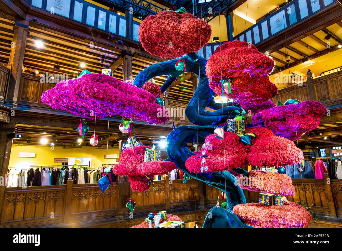A large Christmas tree in a Japanese bonsai style made of reindeer moss suspended from the ceiling at Liberty London, UK Stock Photo