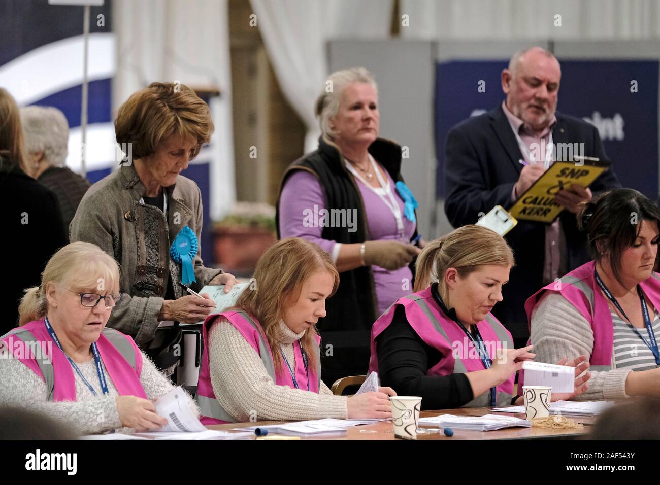 Kelso, Scotland. 12 Dec, 2019. UK Elections: Count, Berwickshire, Roxburgh And Selkirk Constituency - Kelso, UK **** counting staff process ballot papers *** Candidates in the Berwickshire, Roxburgh And Selkirk Constituency Ian Davidson, Scottish Labour Party Calum Kerr, Scottish National Party (SNP) John Lamont, Scottish Conservative And Unionist Party Jenny Marr, Scottish Liberal Democrats . *** Total Electorate for the constituency - 74,518 Number of polling places - 96 Number of Ballot Boxes - 127 from polling stations plus up to 22 postal vote boxes. Maximum 149 boxes. Credit: Rob Gray/Al Stock Photo