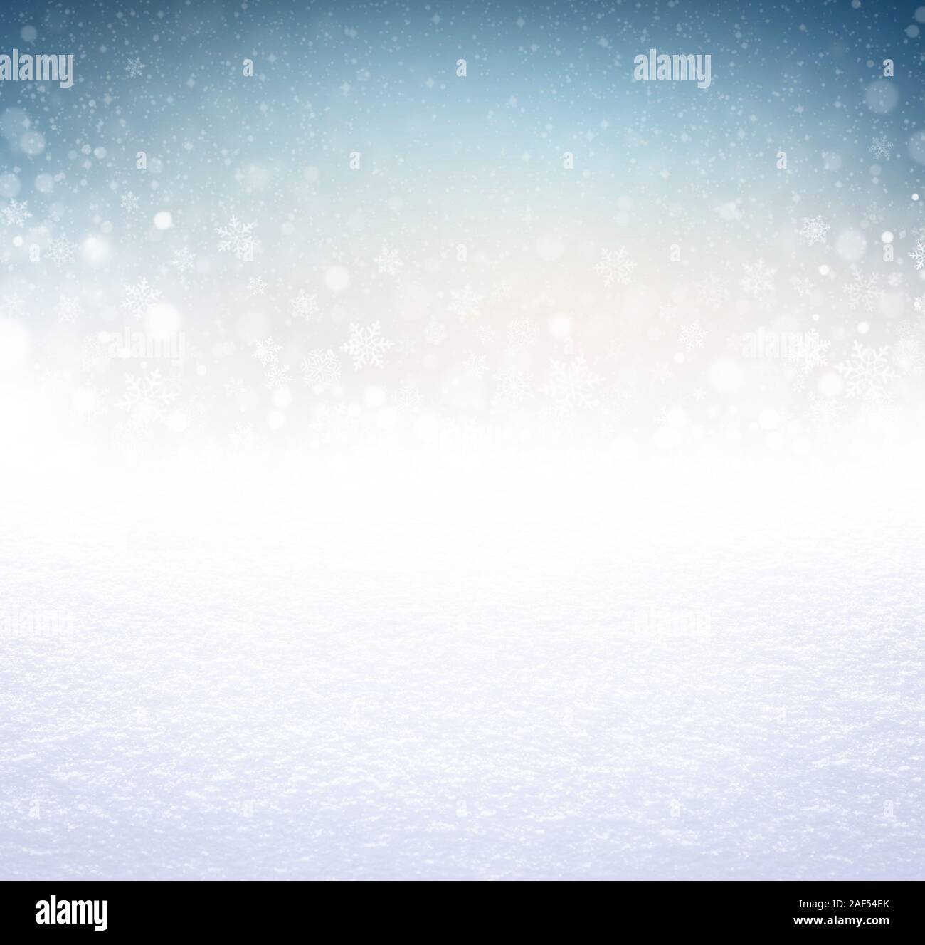 Snowflakes and snowfall on a cold blue winter background and a powder snow ground Stock Photo