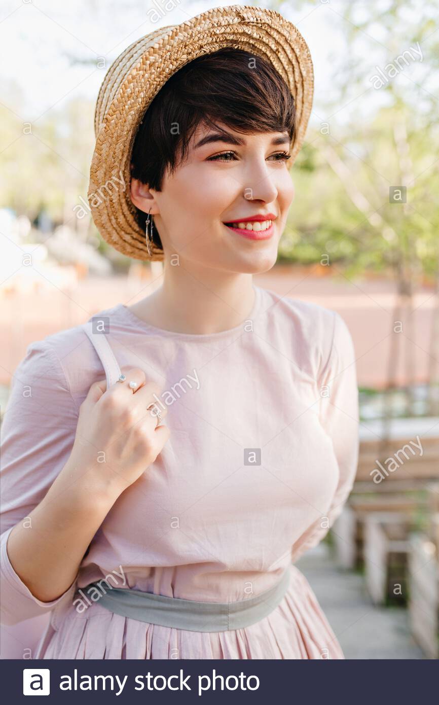 Cute Short Haired Girl Dreamy Smiling Looking Away During Walk In