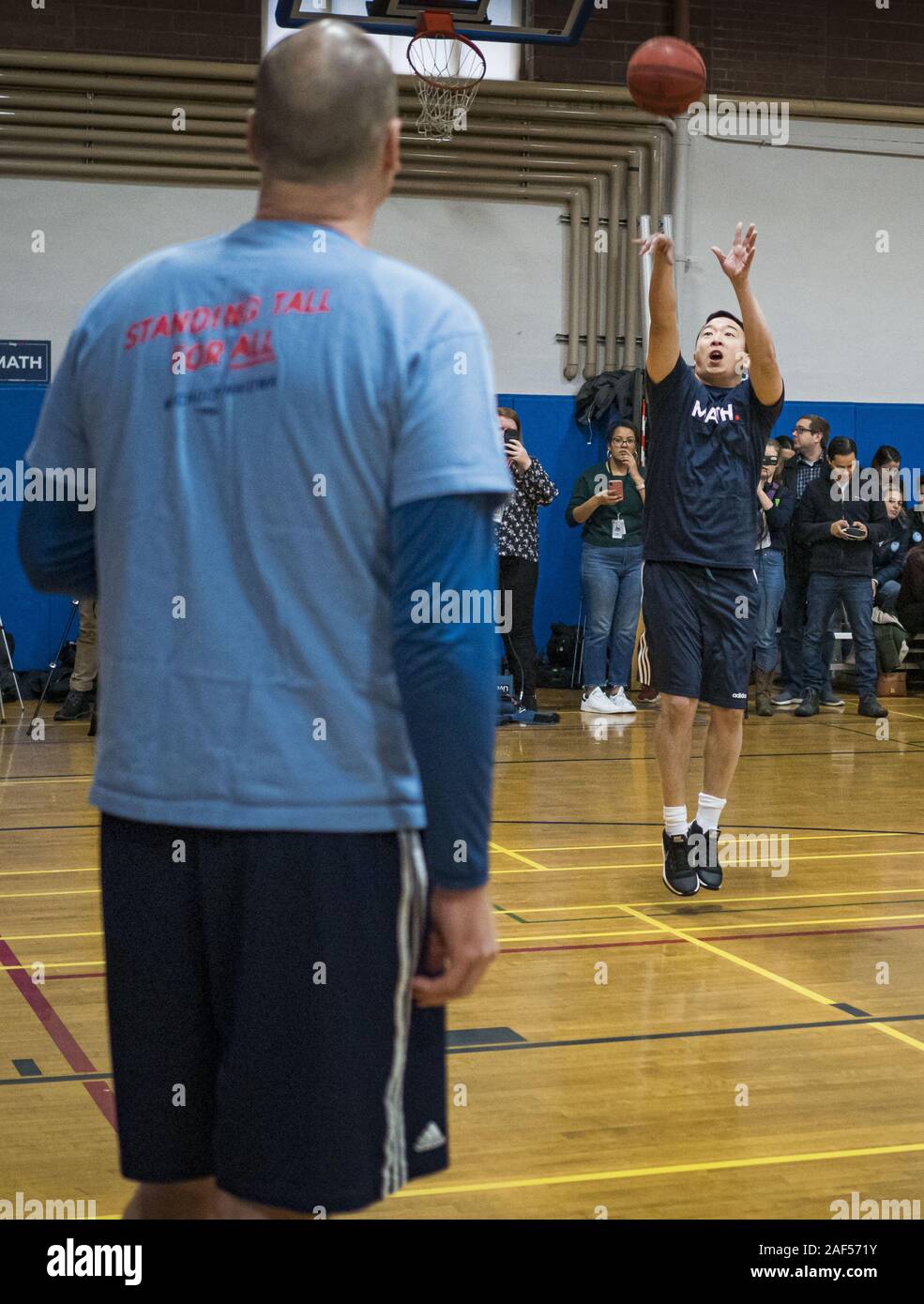 Ames, Iowa, USA. 12th Dec, 2019. ANDREW YANG takes a shot against J.D.  SCHOLTEN during a basketball game with Scholten in the gym in the Ames, IA,  City Hall. Scholten is an