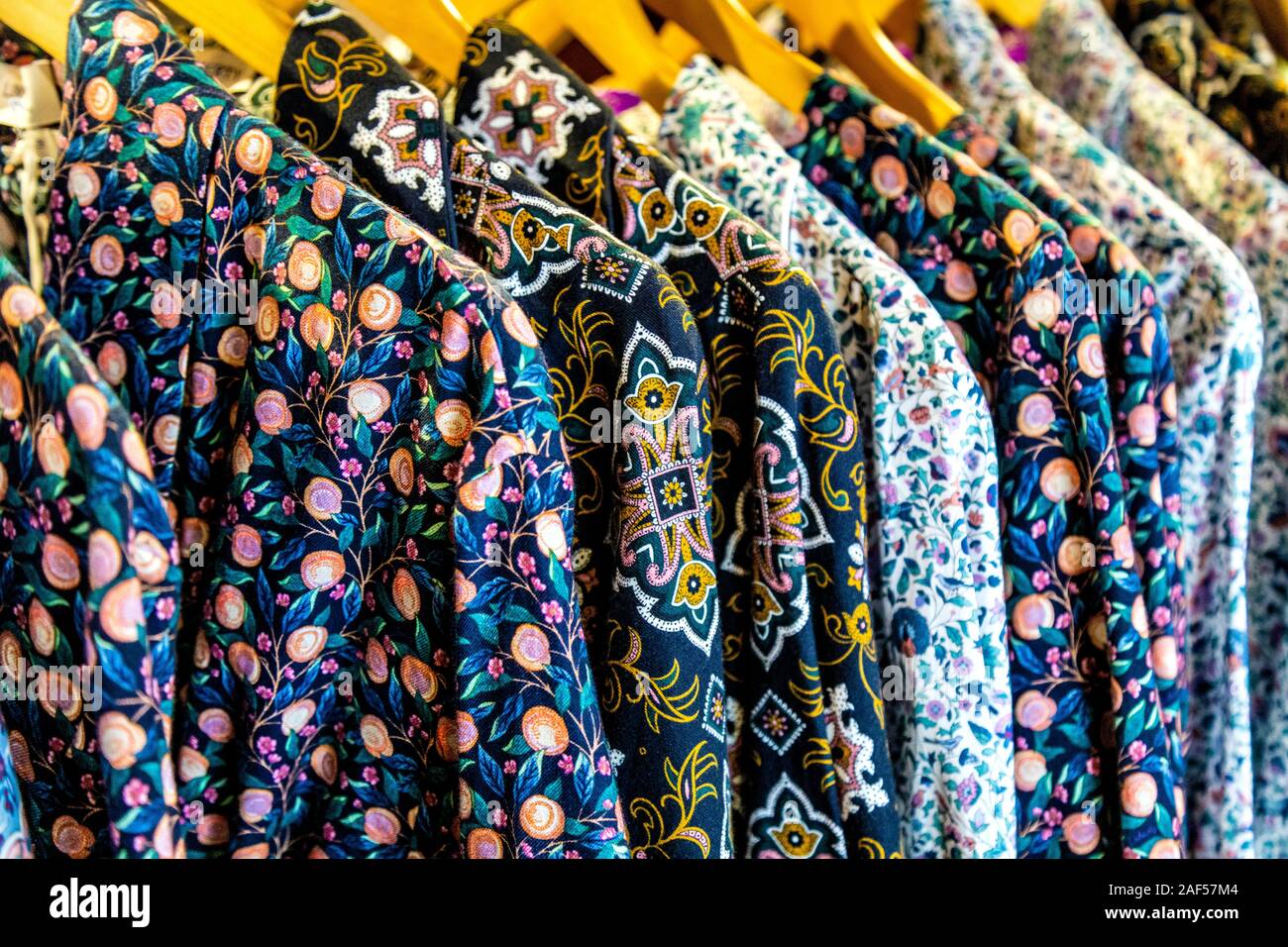 Pyjama shirts with Liberty's patterns hanging on a rail at Liberty London department store, London, UK Stock Photo