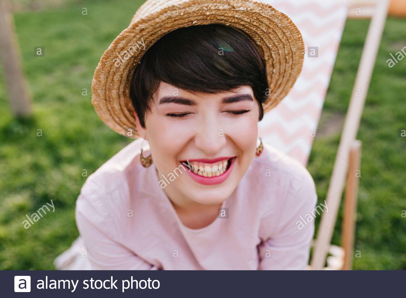 Happy Brunette Girl In Trendy Summer Hat And Cute Earrings