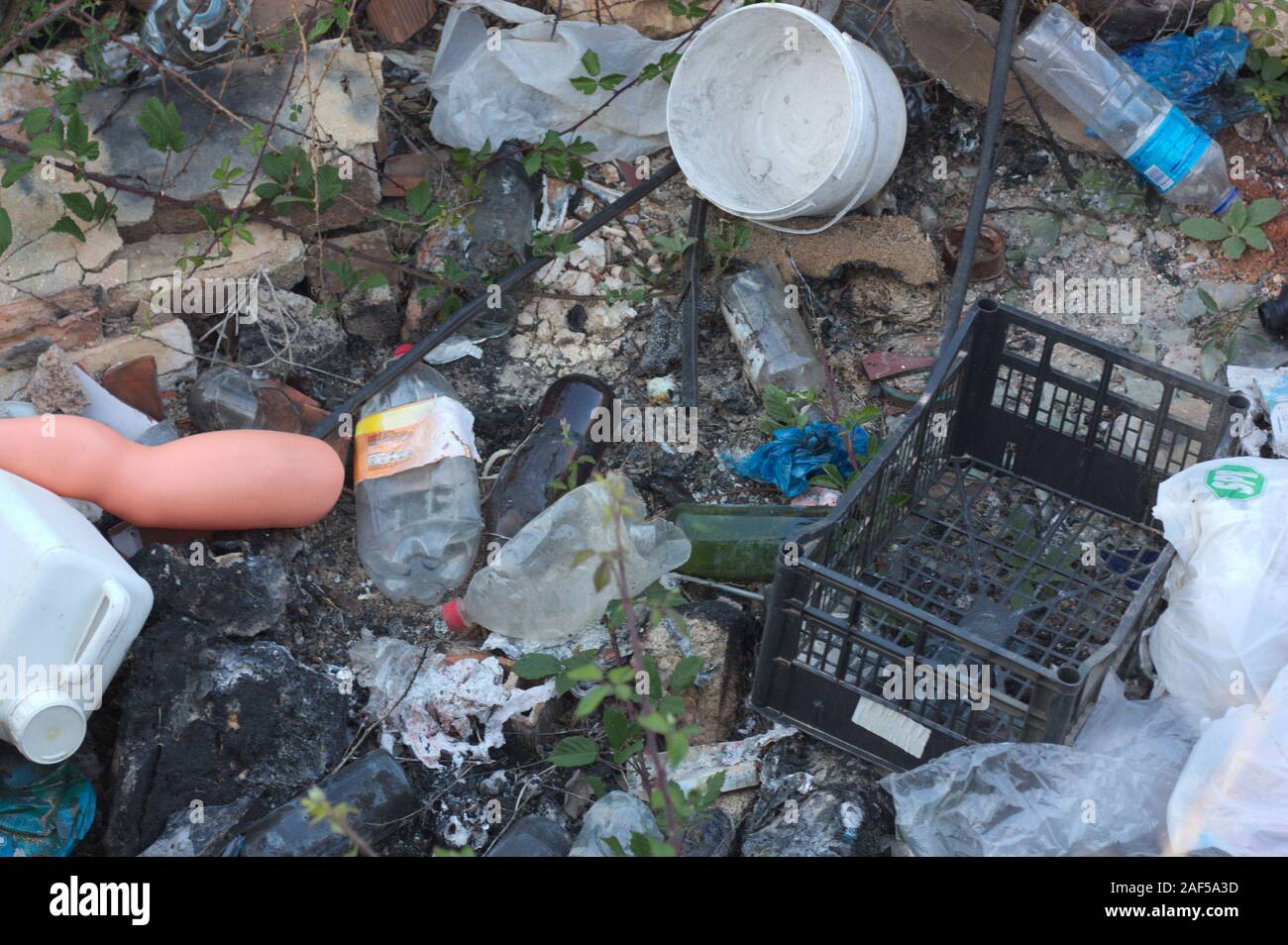 A pile of garbage of all kinds accumulated by man in the middle of