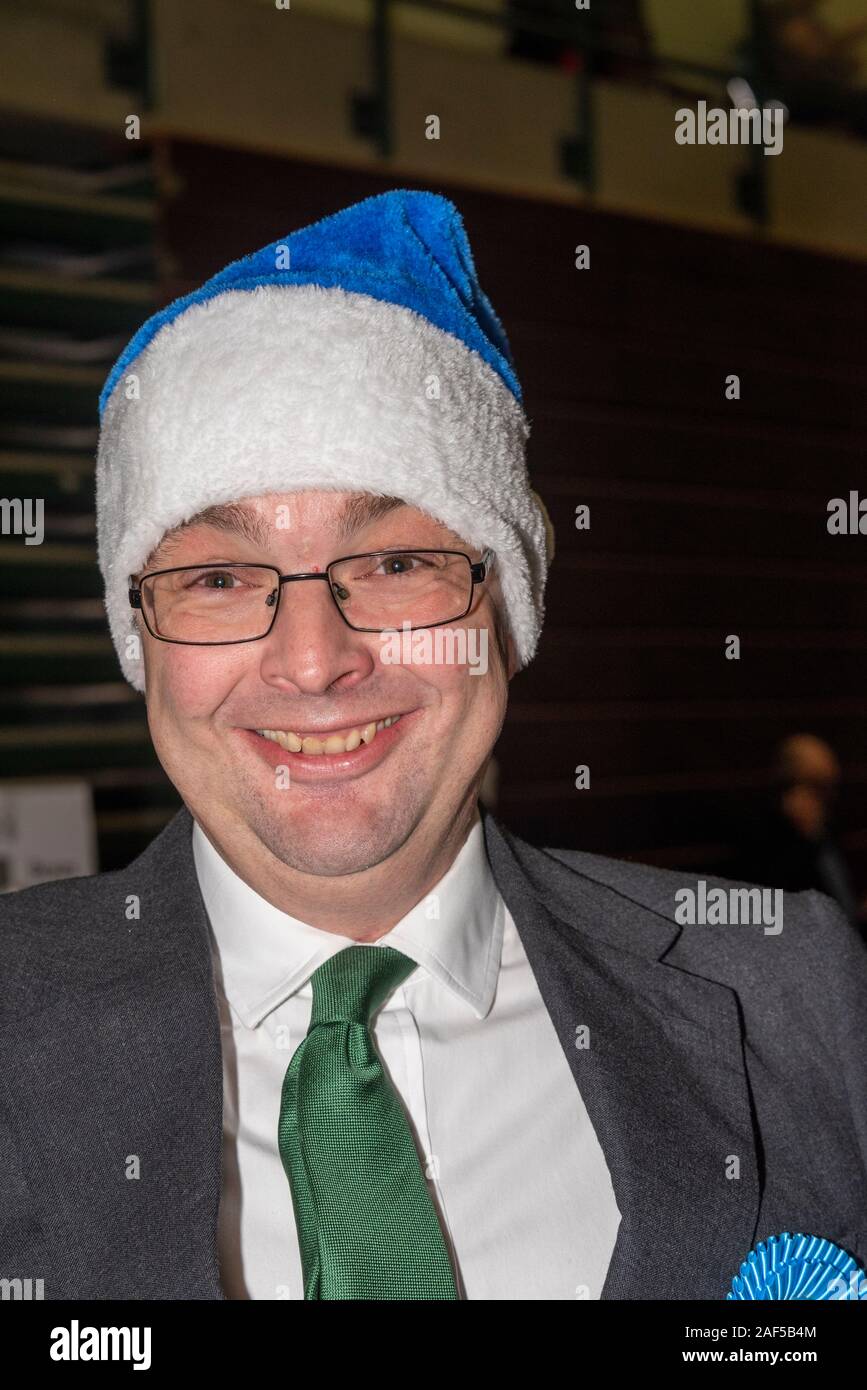 Southend on Sea, Essex, UK. Ballots have begun to be counted at the counting hall for both the Southend West, and Rochford and Southend East constituencies. Conservative candidate James Duddridge arrived, and is seen wearing a festive blue hat. Stock Photo