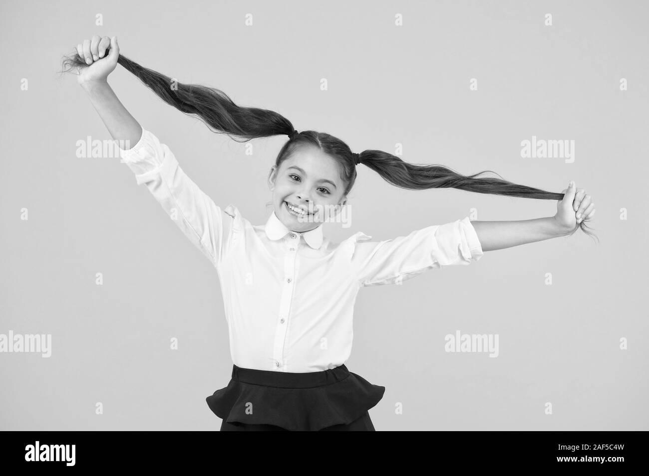 Schoolgirl pupil long hair cute ponytails hairstyle. Educational Schoolgirl pupil long hair cute ponytails hairstyle. Educational