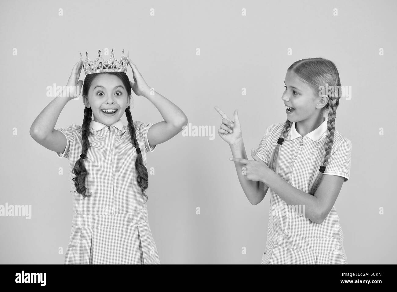 Little princess. Motivational award for school children. Succeed in education. Celebrating success. She is the best. Happy schoolgirls and golden crown symbol of success. Success and respect. Stock Photo