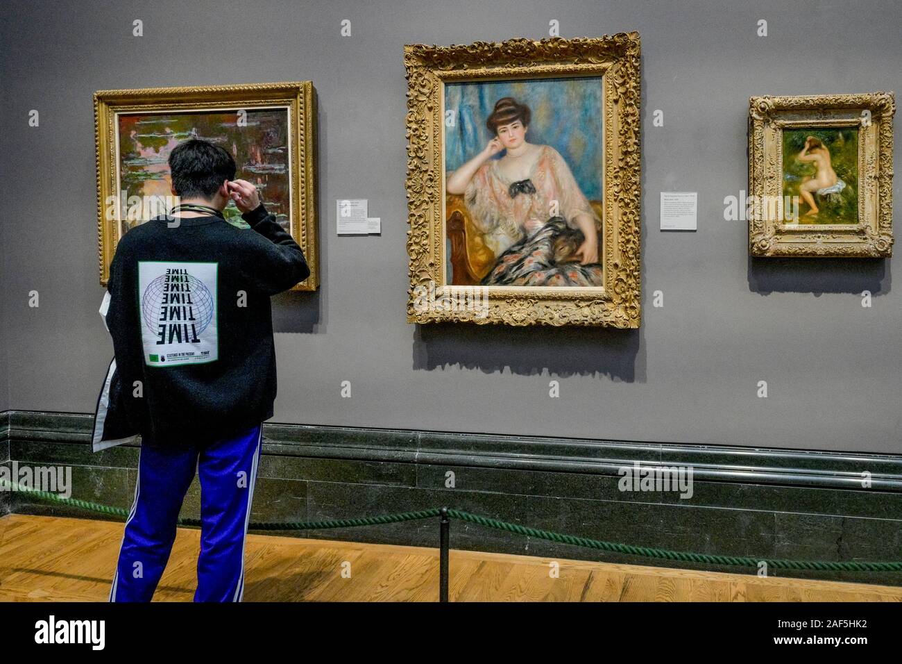 Man looks at portrait of Misia Godebska-Sert by Pierre-Auguste Renoir, National Gallery, London, England, UK Stock Photo
