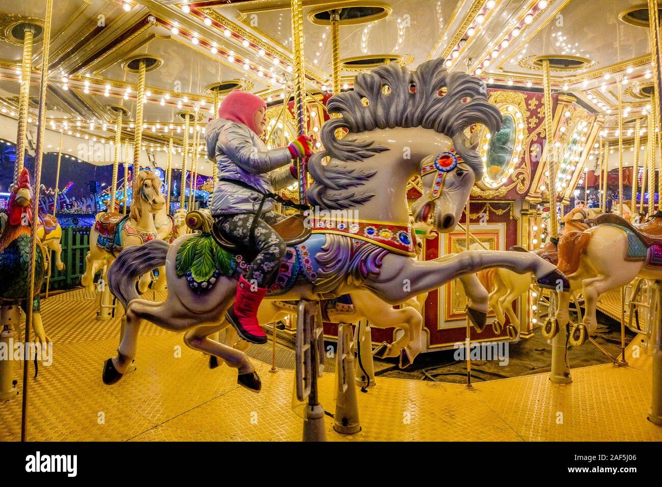 Girl on carousel horse, Hyde Park Winter Wonderland, Fun fair, London, England, UK Stock Photo