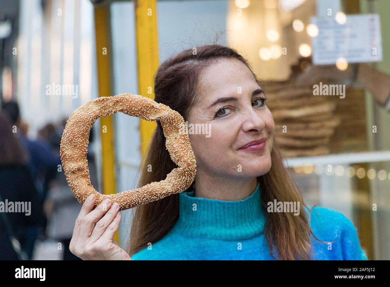 Greek woman holding a greek traditional koulouri. Stock Photo