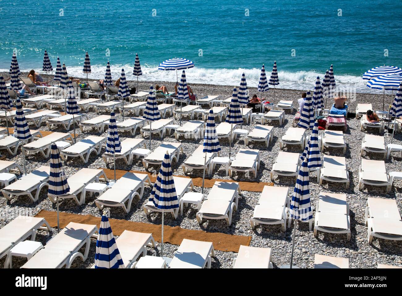 The beach at Nice on the French Riviera on a warm Spring day in France Stock Photo