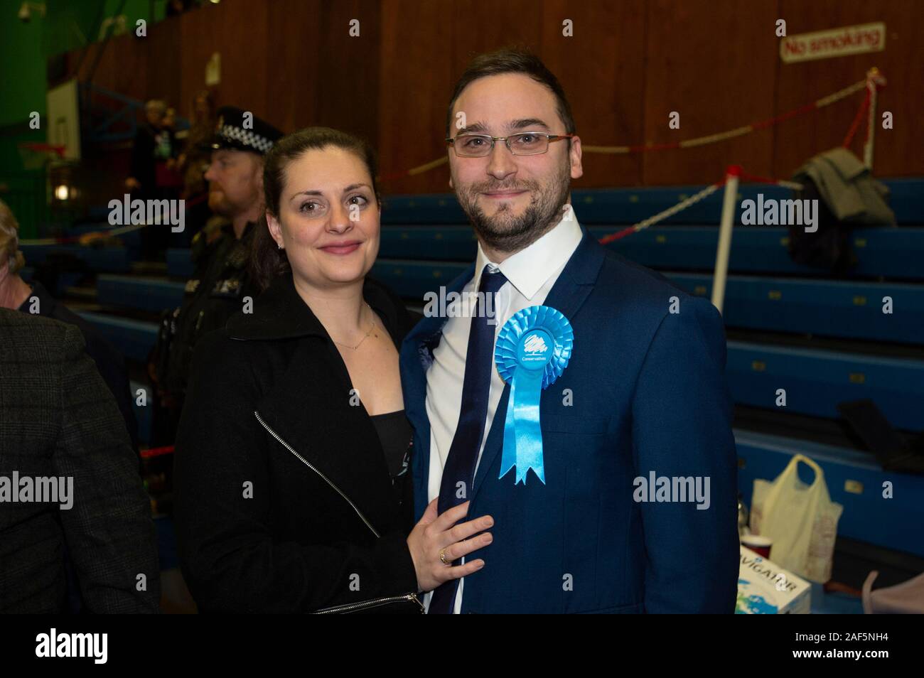 Bury, UK. 13th December 2019. Conservative candidate Christian Wakeford (right) smiles after his win as the results are announced for the UK election 2019 for the parliamentary constituency of Bury South, held at Castle Leisure Centre. Credit: Russell Hart/Alamy Live News Stock Photo