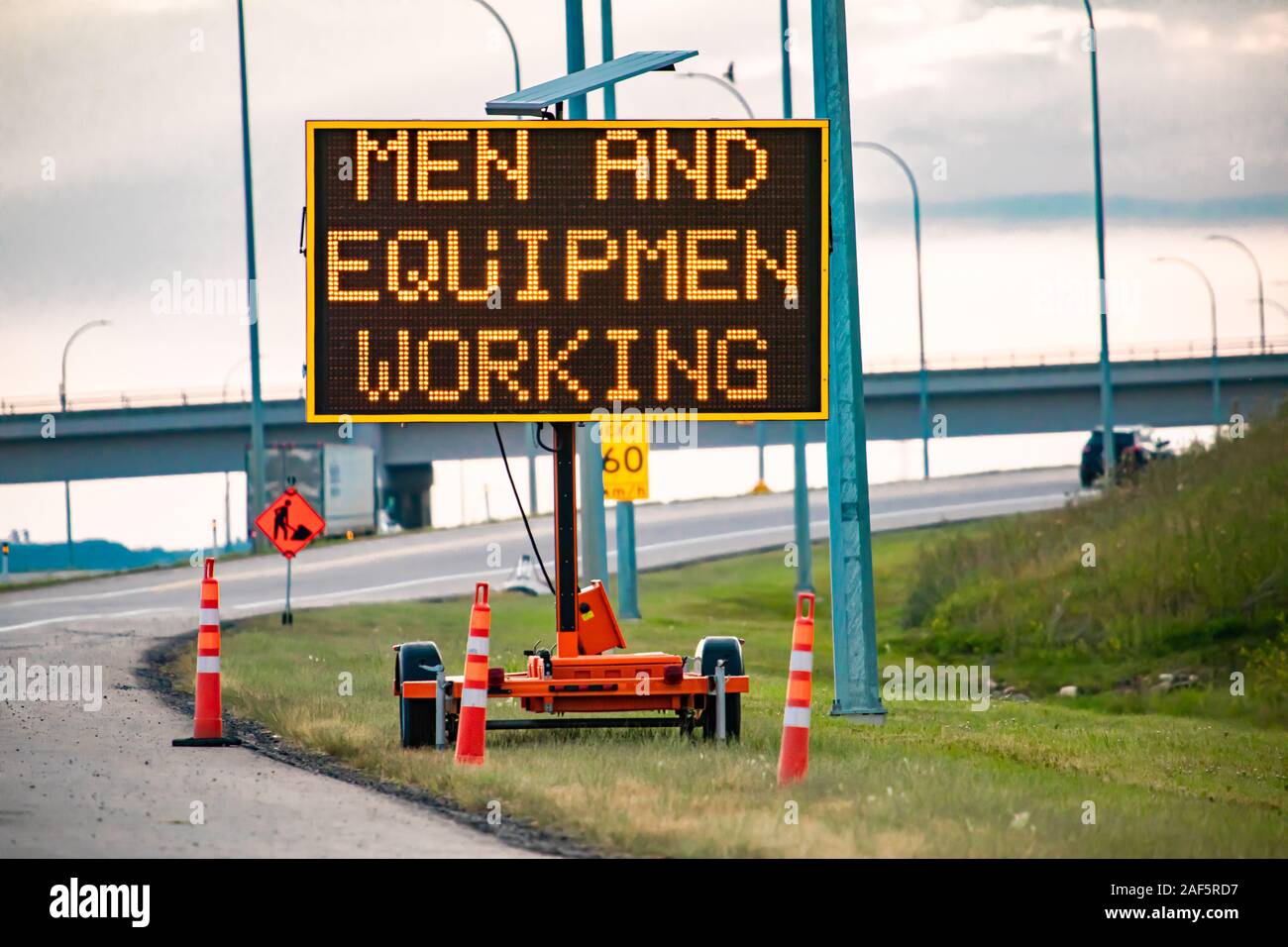 Temporary condition Variable message sign with orange barrels on the