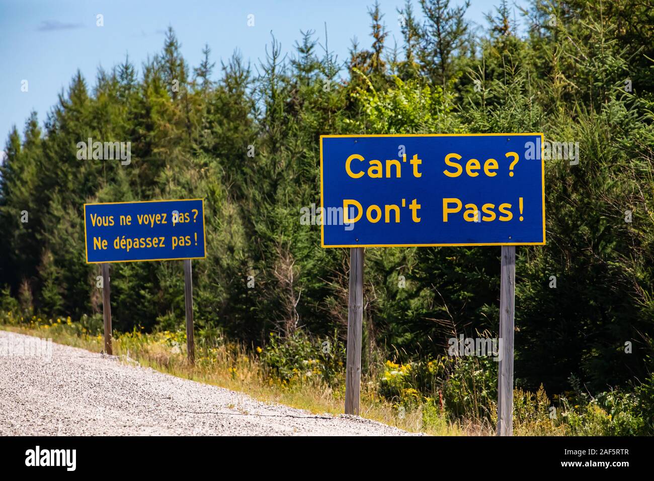 French and English Information road blue signs, You cannot see, do not  overtake, Canadian rural country roadside, Ontario, Canada Stock Photo -  Alamy