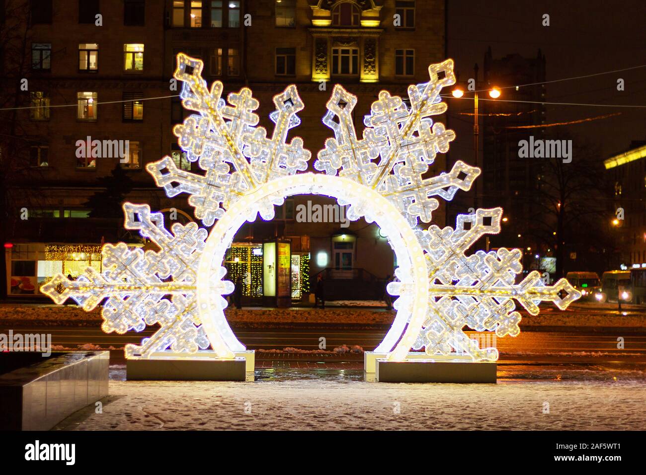 large snowflake decorations illuminated a fabulous atmosphere in the city Stock Photo