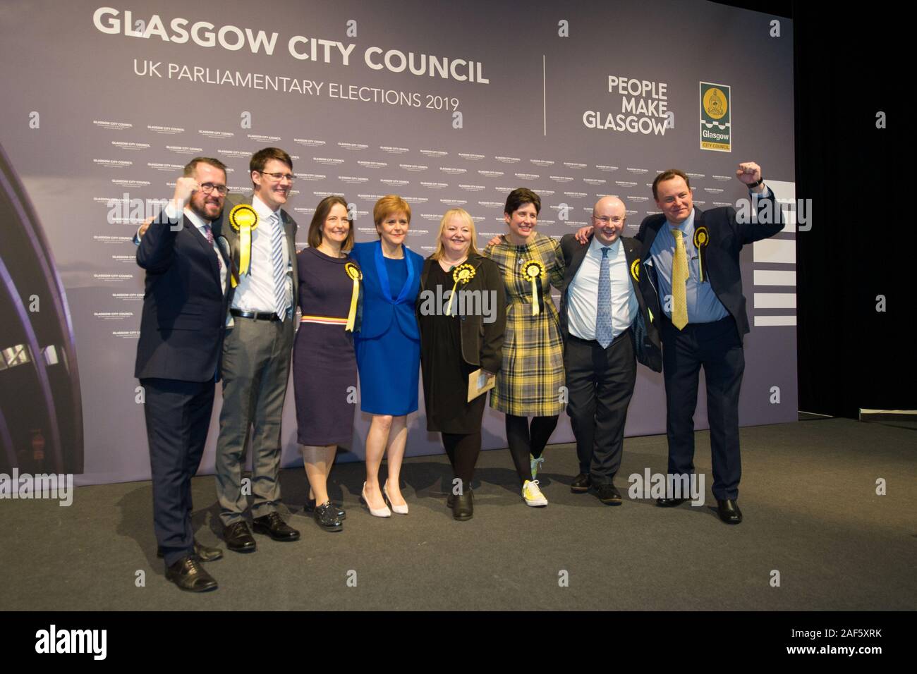 Glasgow, UK. 13th Dec, 2019. Pictured: (in blue) Nicola Sturgeon MSP - First Minister of Scotland and Leader of the Scottish National Party (SNP); standing along with hre winning candidates. Scenes from the vote count at the Scottish Exhibition and Conference Centre (SECC). The poles have now closed at 10pm and the vote count is now underway for the UK Parliamentary General Election 2019. This is the first time in almost 100 years that a general election has taken place in December. Credit: Colin Fisher/Alamy Live News Stock Photo