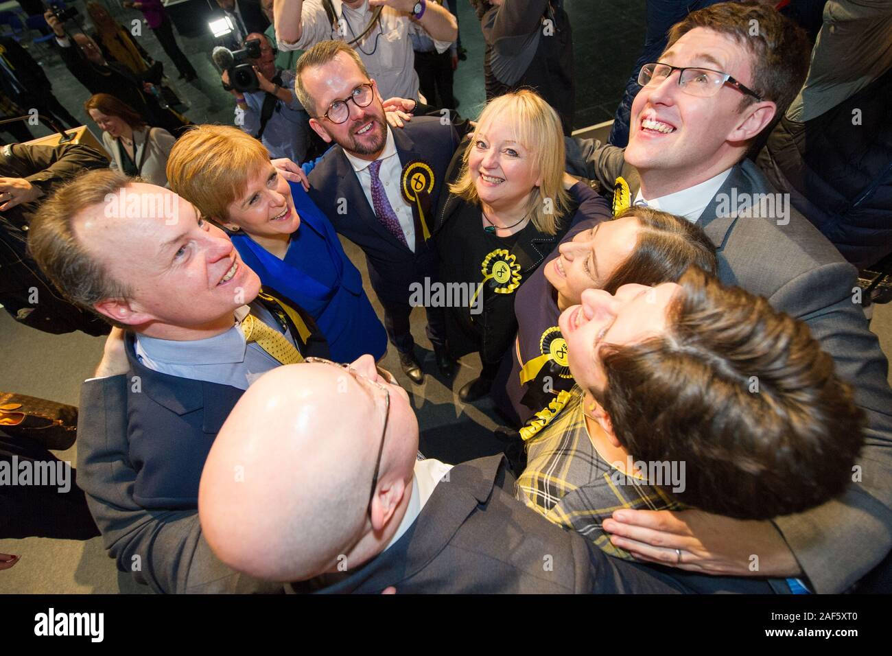 Glasgow, UK. 13th Dec, 2019. Pictured: (in blue) Nicola Sturgeon MSP - First Minister of Scotland and Leader of the Scottish National Party (SNP); standing along with hre winning candidates. Scenes from the vote count at the Scottish Exhibition and Conference Centre (SECC). The poles have now closed at 10pm and the vote count is now underway for the UK Parliamentary General Election 2019. This is the first time in almost 100 years that a general election has taken place in December. Credit: Colin Fisher/Alamy Live News Stock Photo