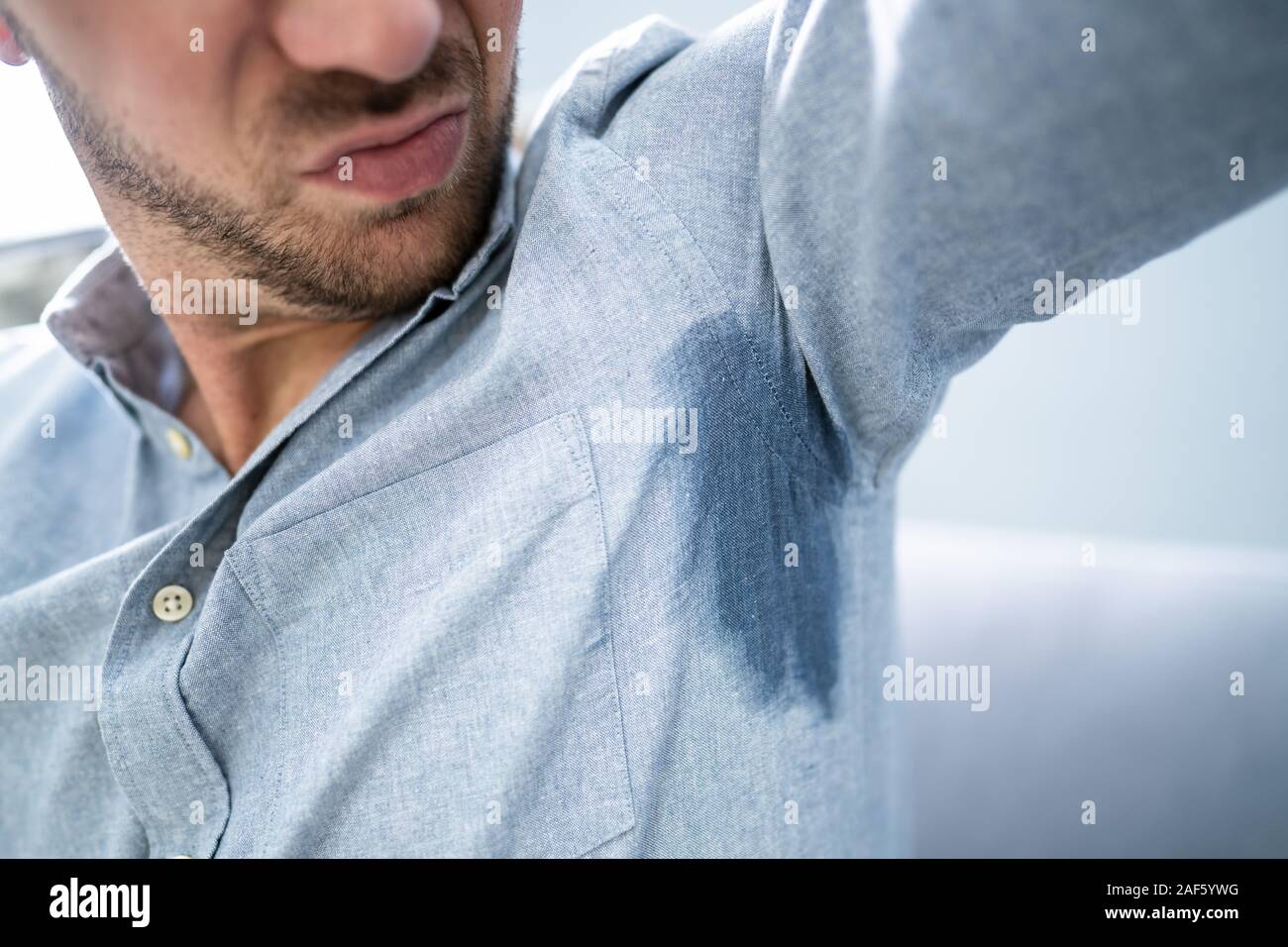 Mature Man Notices His Sweat Under Armpit Stock Photo