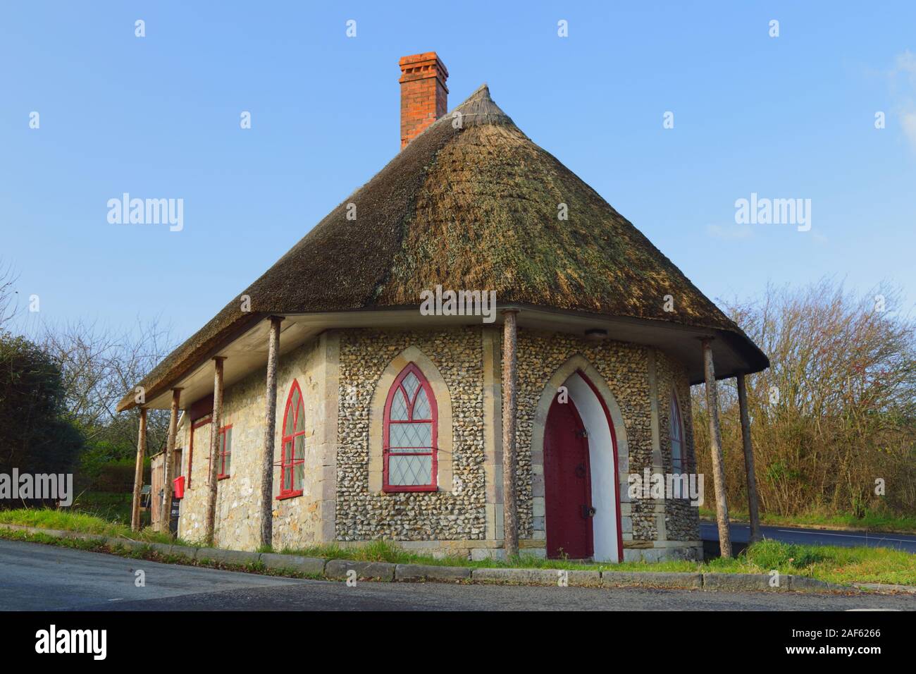 The old toll house near Chard in Somerset. Thatched cottage was built in 1839 in Gothic revival style is a Grade II listed building. Stock Photo