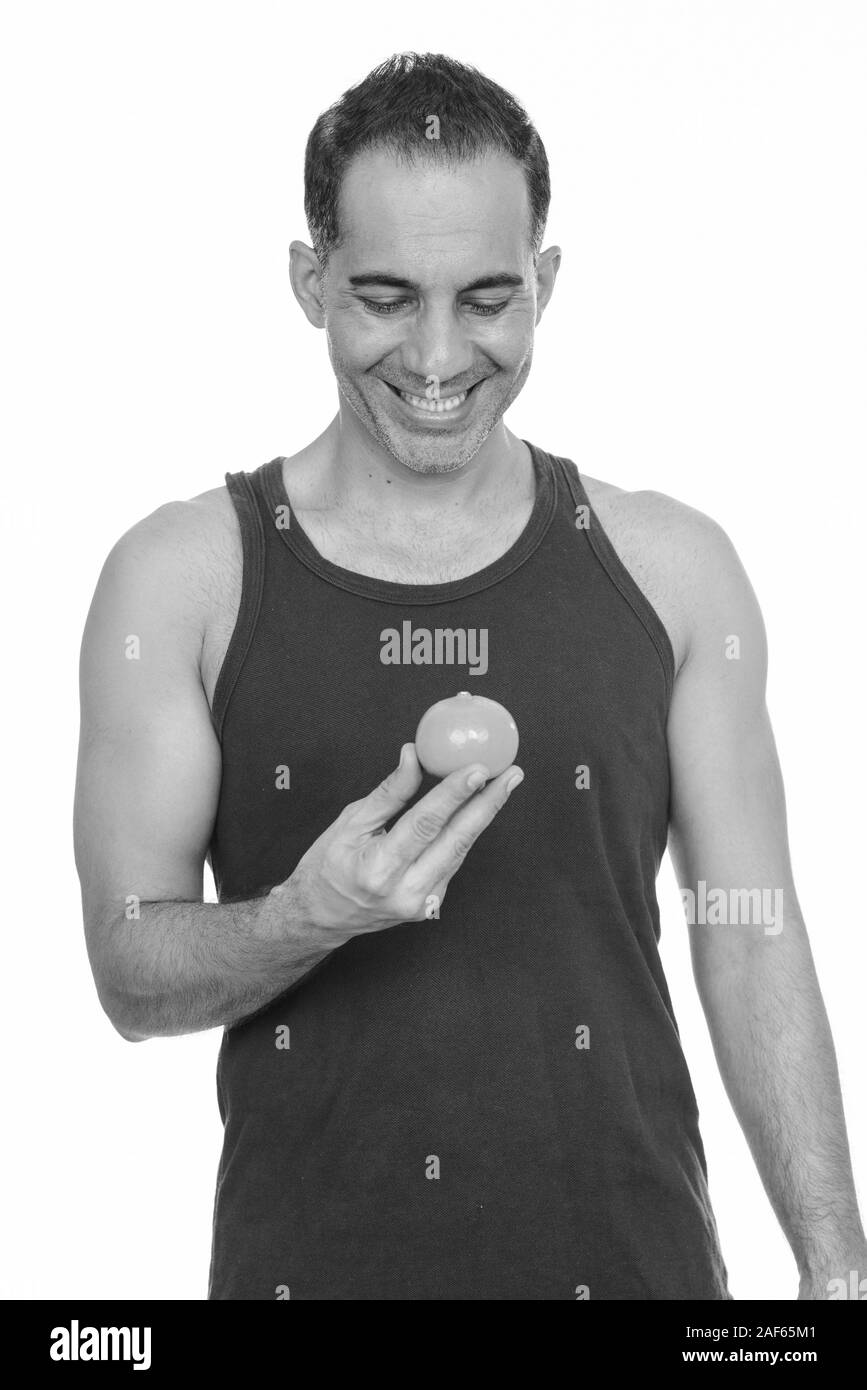 Mature happy Persian man holding orange in black and white Stock Photo ...
