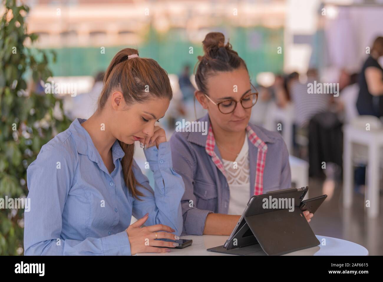 Group women check phones hi-res stock photography and images - Alamy