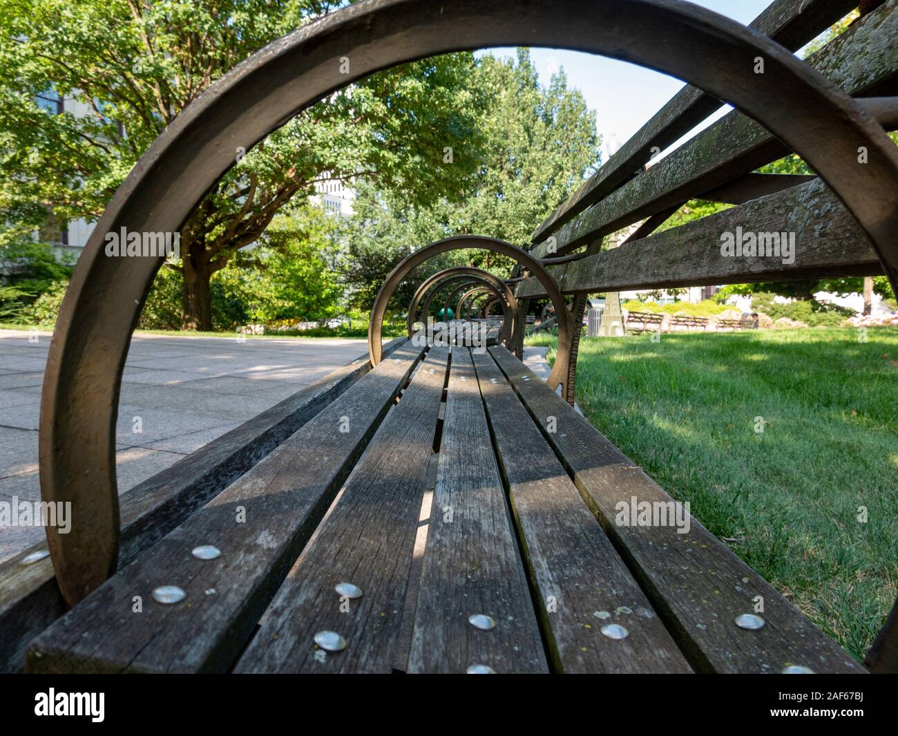 An empty park bench in the city park Stock Photo - Alamy