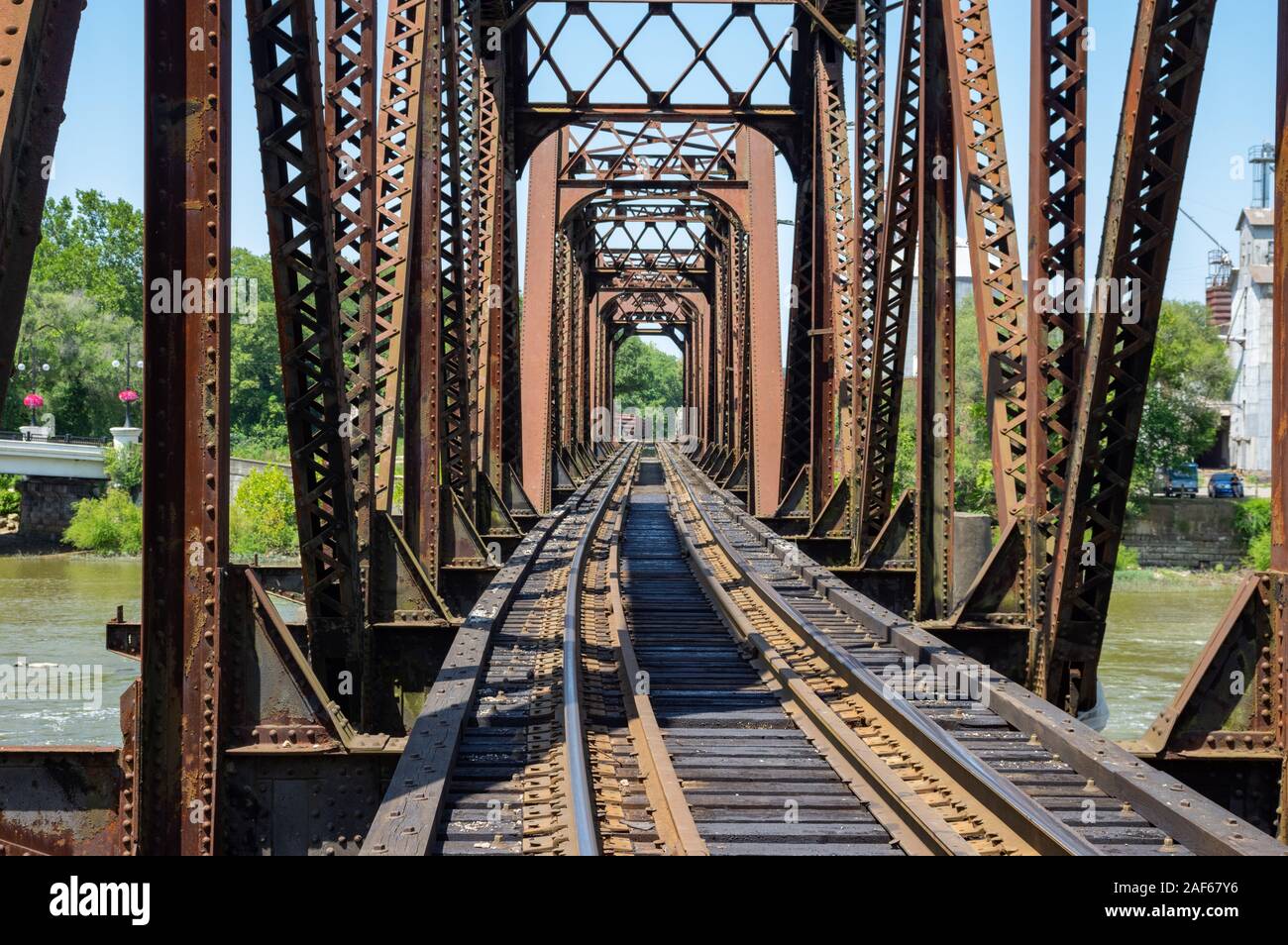An iron structure railroad bridge stretching across a river Stock Photo ...