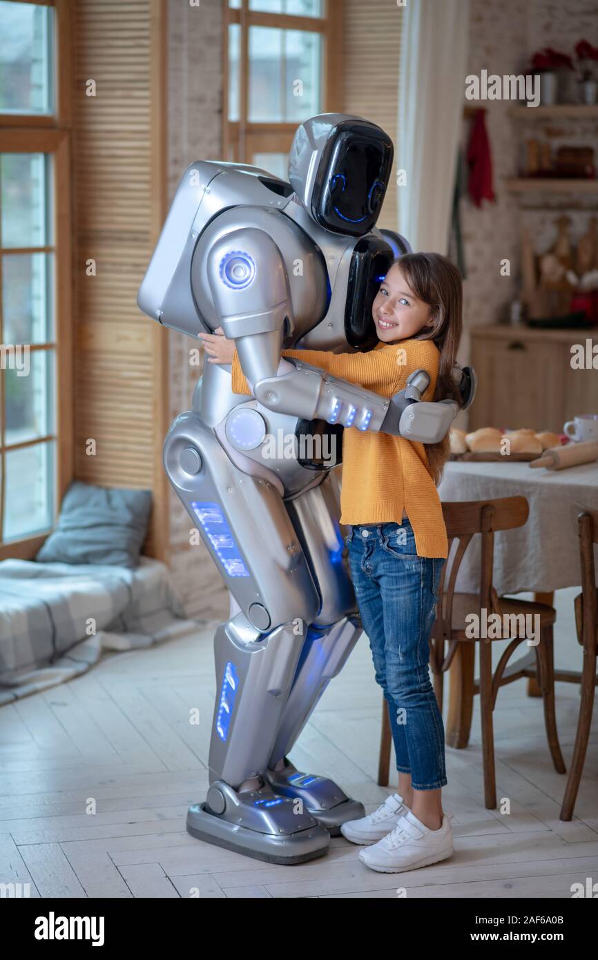 Robot and girl feeling good together at home Stock Photo - Alamy