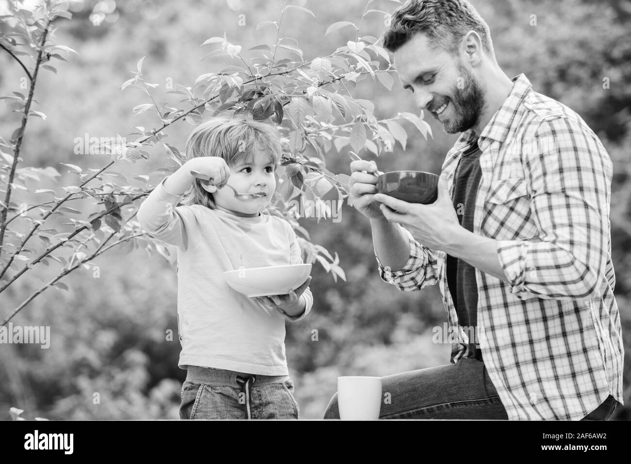 Healthy nutrition concept. Nutrition habits. Family enjoy homemade meal. Healthy breakfast. Father son eat food. Little boy and dad eat. Nutrition kids and adults. Tasty porridge. Organic nutrition. Stock Photo