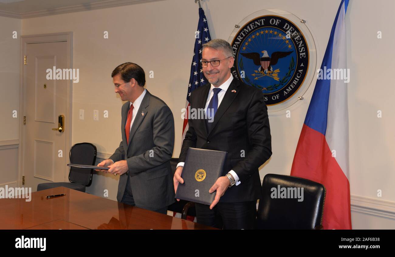 Czech Defence Minister Lubomir Metnar, right, and U.S. Defense Secretary Mark Esper, left, signed an inter-government deal on the Czech purchase of 12 military helicopters worth 14.6 billion crowns, supplied by the Bell company, in Washington, USA, on December 12, 2019. In the Czech military equipment, the helicopters will replace the outdated Russian combat helicopters Mi-24/35. The Czech air force will acquire eight UH-1Y Venom multipurpose helicopters and four AH-1Z Viper combat helicopters. The supply is scheduled for 2023. (CTK Photo/Karel Capek) Stock Photo