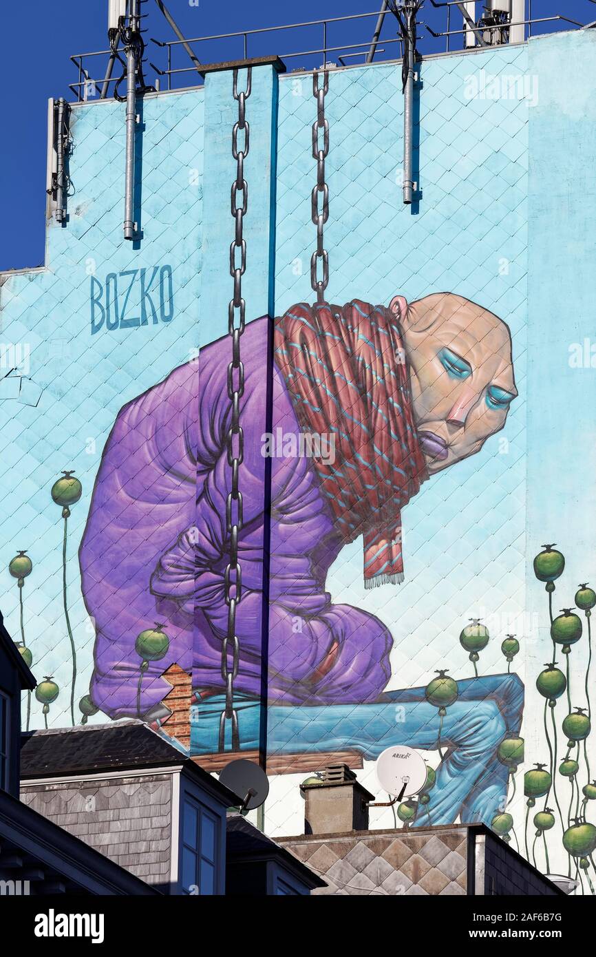 Drug addict sits between poppy capsules, heroin addict, Mural of Bozko, Streetart, Brussels, Belgium Stock Photo