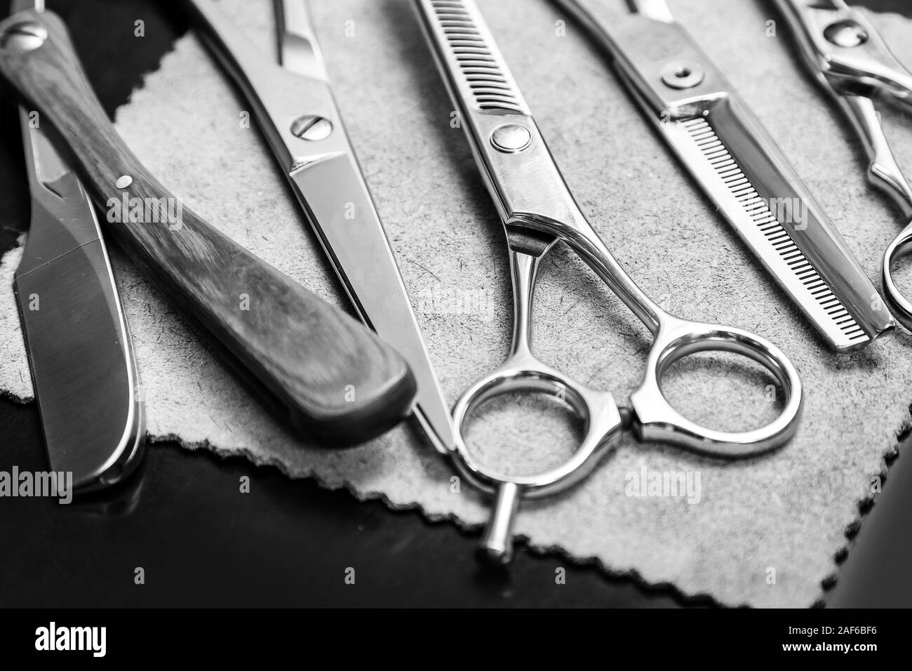 Straight razor and different scissors in hairdressing salon Stock Photo
