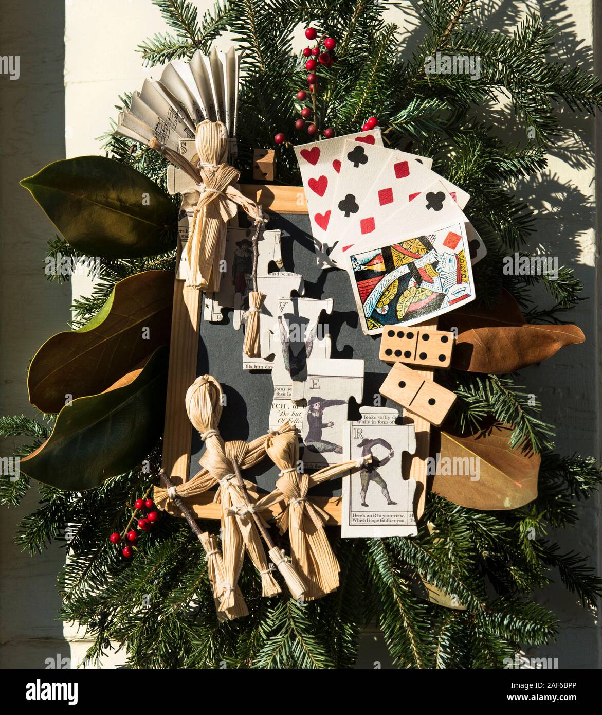 Tavern themed wreath made of dominoes, stick people, sheet music fan