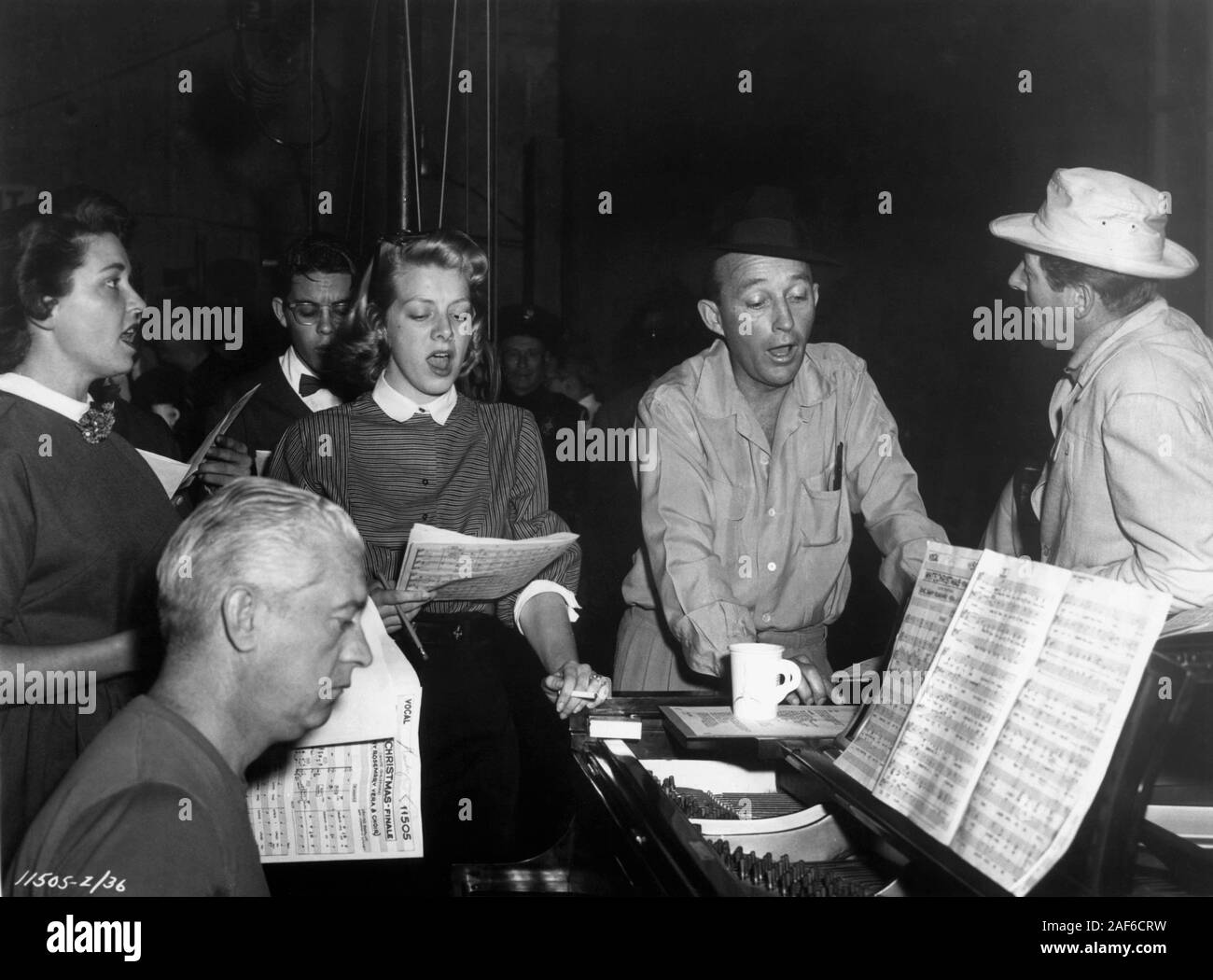 ROSEMARY CLOONEY BING CROSBY DANNY KAYE and Choir Members rehearsing White Christmas Finale with music director / vocal arranger JOSEPH J. LILLEY at Paramount Recording Studio for WHITE CHRISTMAS director Michael Curtiz songs Irving Berlin Paramount Pictures Stock Photo