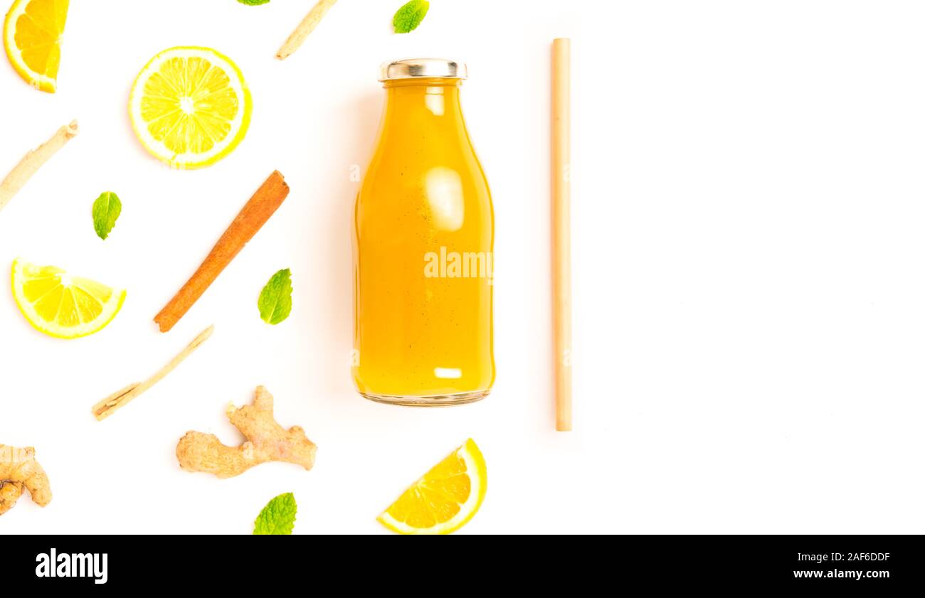 ginger and citrus healthy drink in glass bottle with other ingredients - lay flat healthy lifestyle concept image with copy space for text. Stock Photo