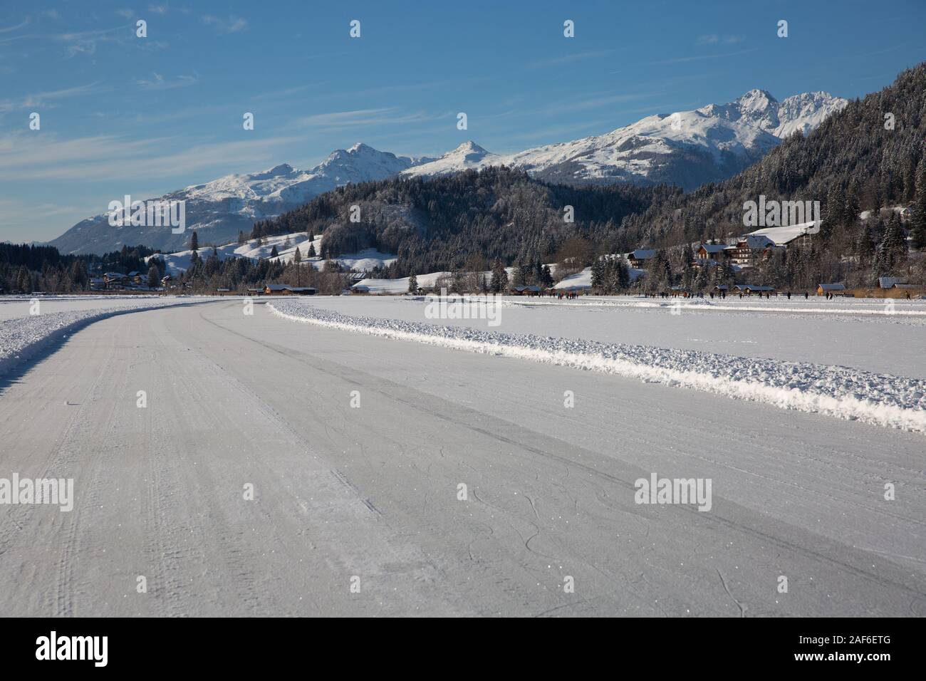 Ice skating trail - Lake Weissensee.The Weissensee Nature Park becomes in  winter the largest frozen ice surface in Europe, Carinthia, Alps, Austria  Stock Photo - Alamy