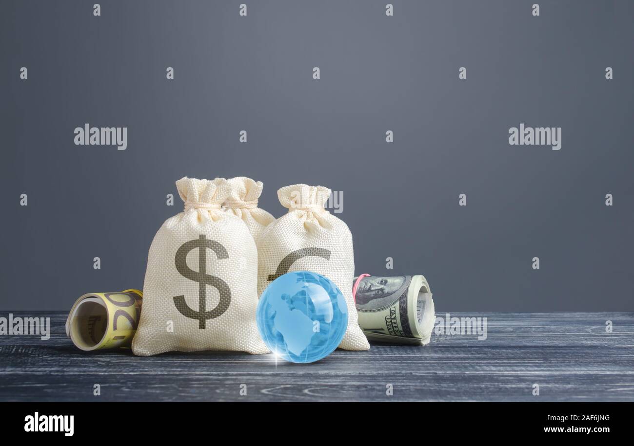 Money bags and world currencies. Capital investment, savings. Economics, lending business. Profit income, dividends payouts. Crowdfunding startups inv Stock Photo