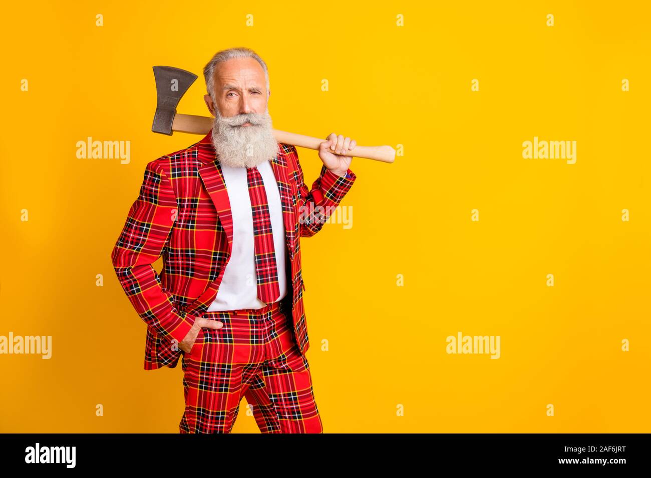 Photo of cool grandpa white beard holding big ax hands playing serial killer role at halloween wear plaid red costume outfit isolated bright yellow Stock Photo