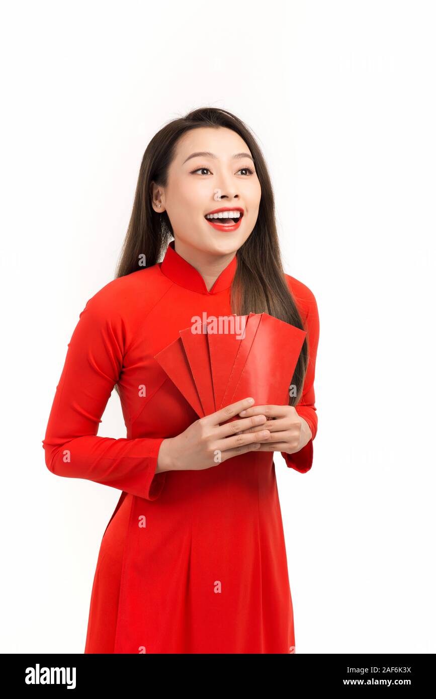 Happy chinese new year and Lunar new year, Attractive Asian woman dress traditional ao dai holding red envelopes or ang pow or red packet monetary gif Stock Photo