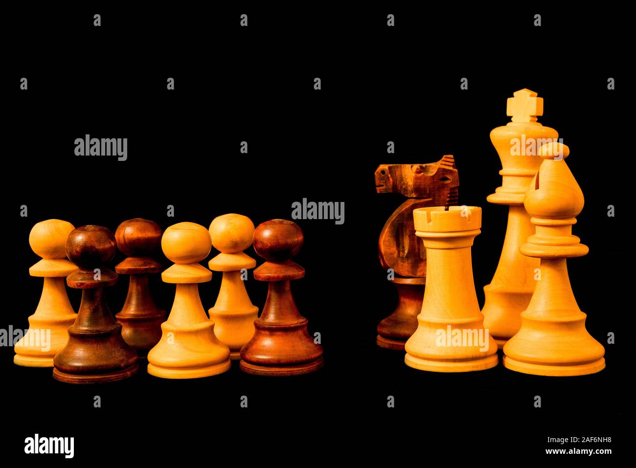Political and economic against the common people. Rich versus poor concept. Standard chess wooden piece on black background Stock Photo