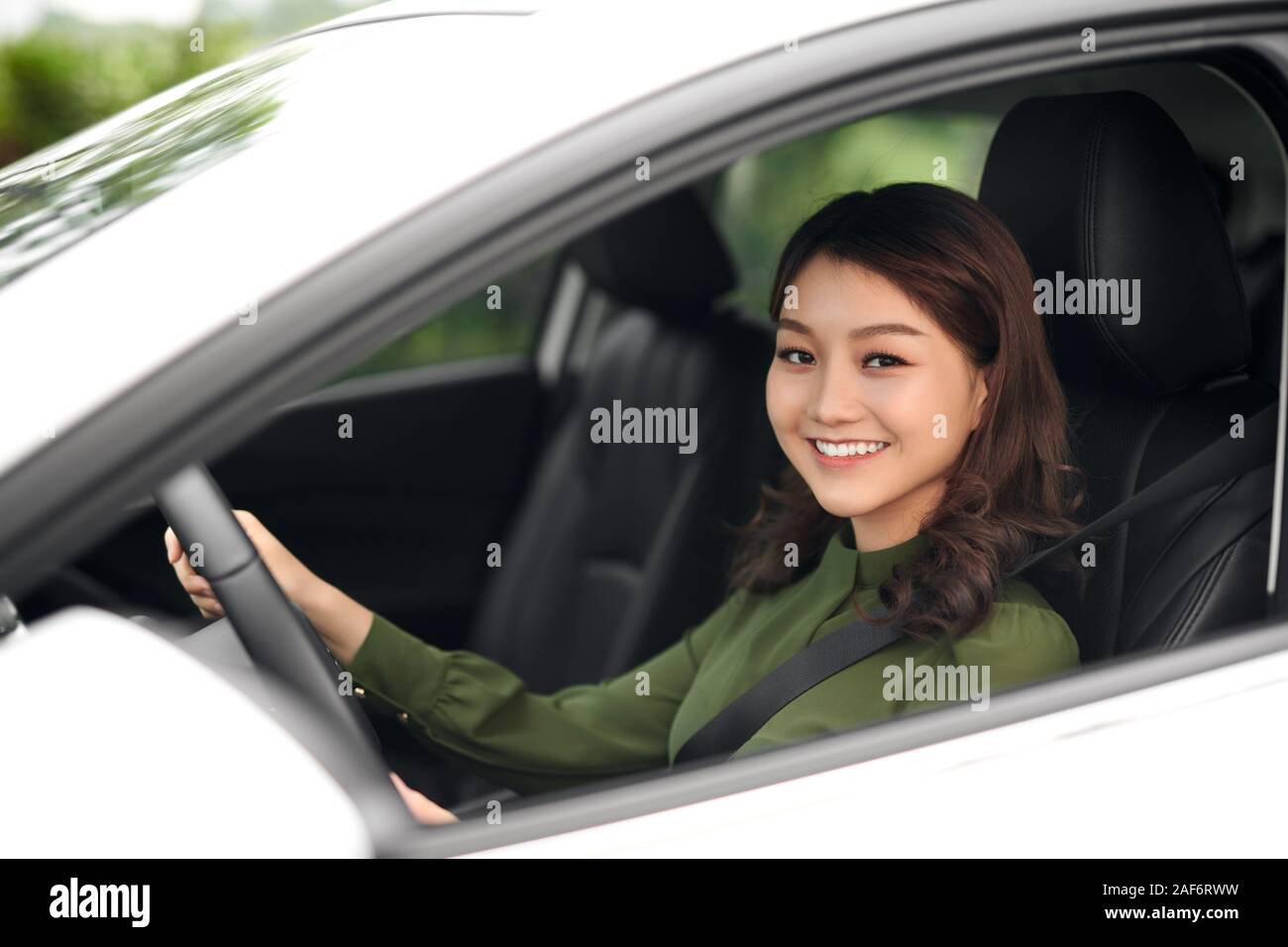 Beautiful woman sitting at the wheel of a car Stock Photo - Alamy