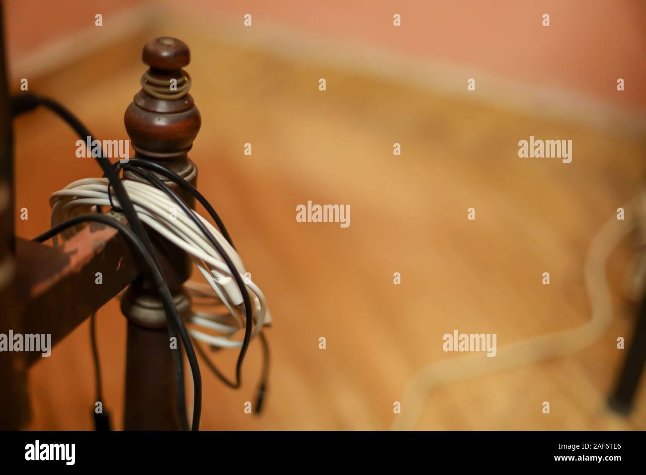 Smartphone cable or broken phone cable hangs on desks Stock Photo