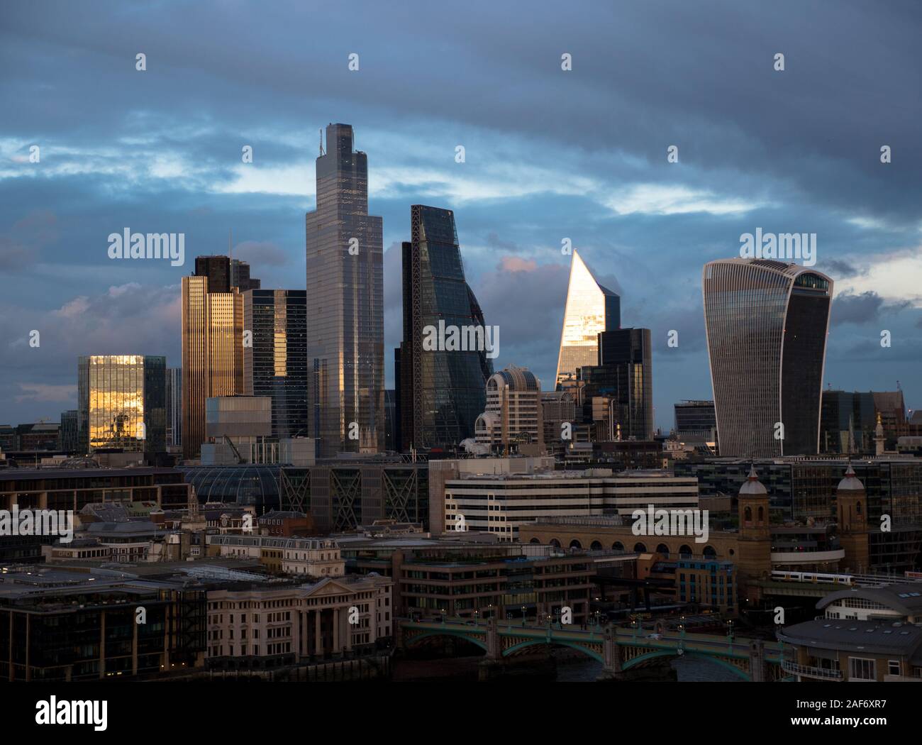 Sun Setting on The City of London, UK Business Centre, Winter Storm Clouds, London, England, UK, GB. Stock Photo